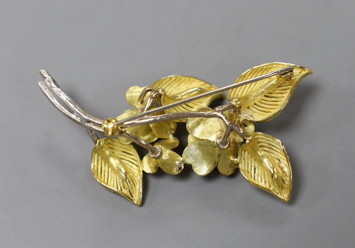 A 1960's two colour 18ct gold and diamond chip set floral spray brooch, maker CJ Ltd